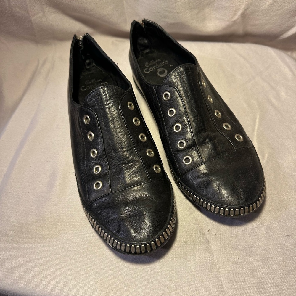 Colleen Cordero black leather slip ons, zips up the back, metal detail. 8.5